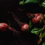 close up photo of beetroots on black background