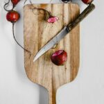 red cherries on brown wooden chopping board